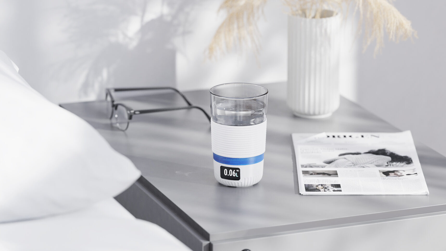 aquatime intelligent drinking glass next to white bed on bedside table